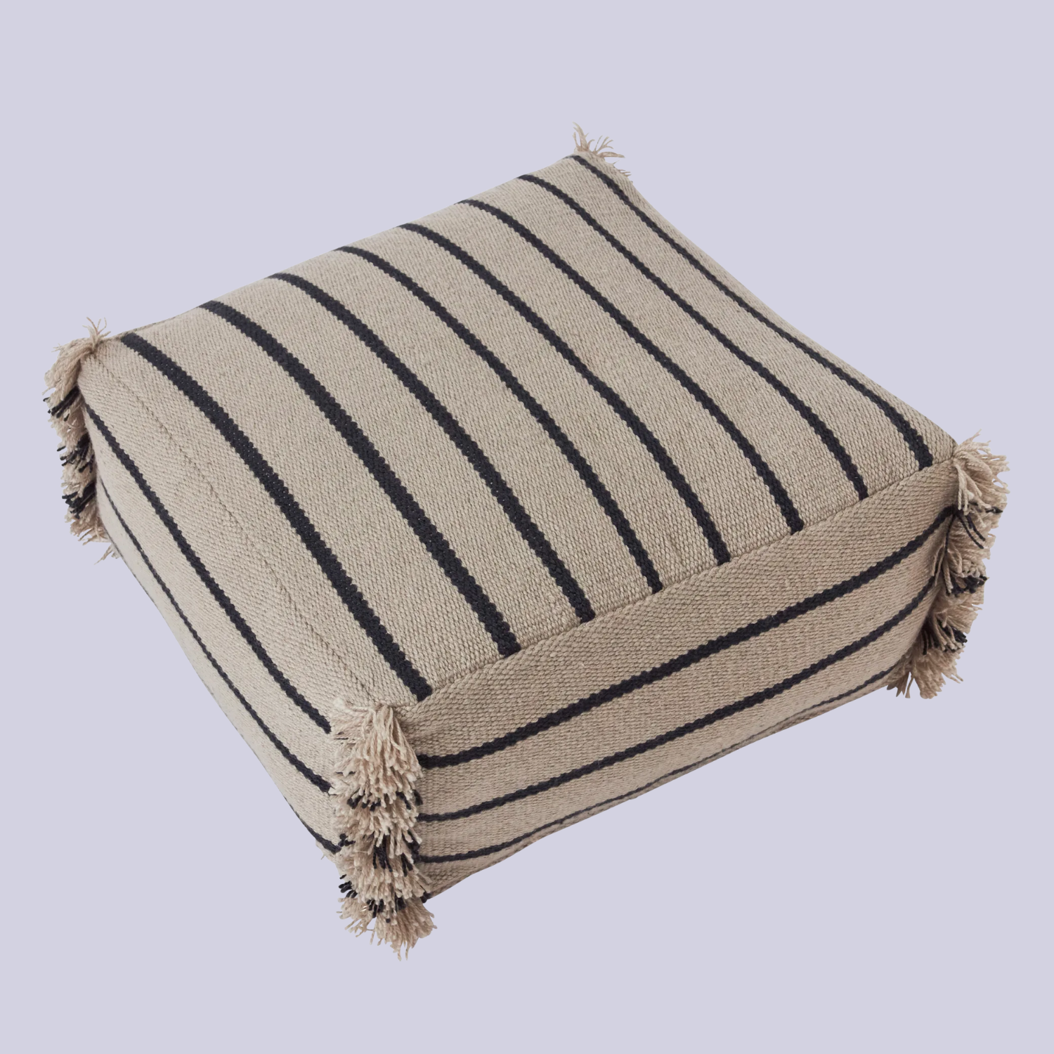 A striped pouffe with a fringe detail on the corners