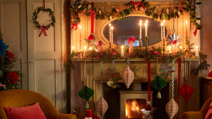 a holiday mantel decorated with various types of garland and paper Christmas decor