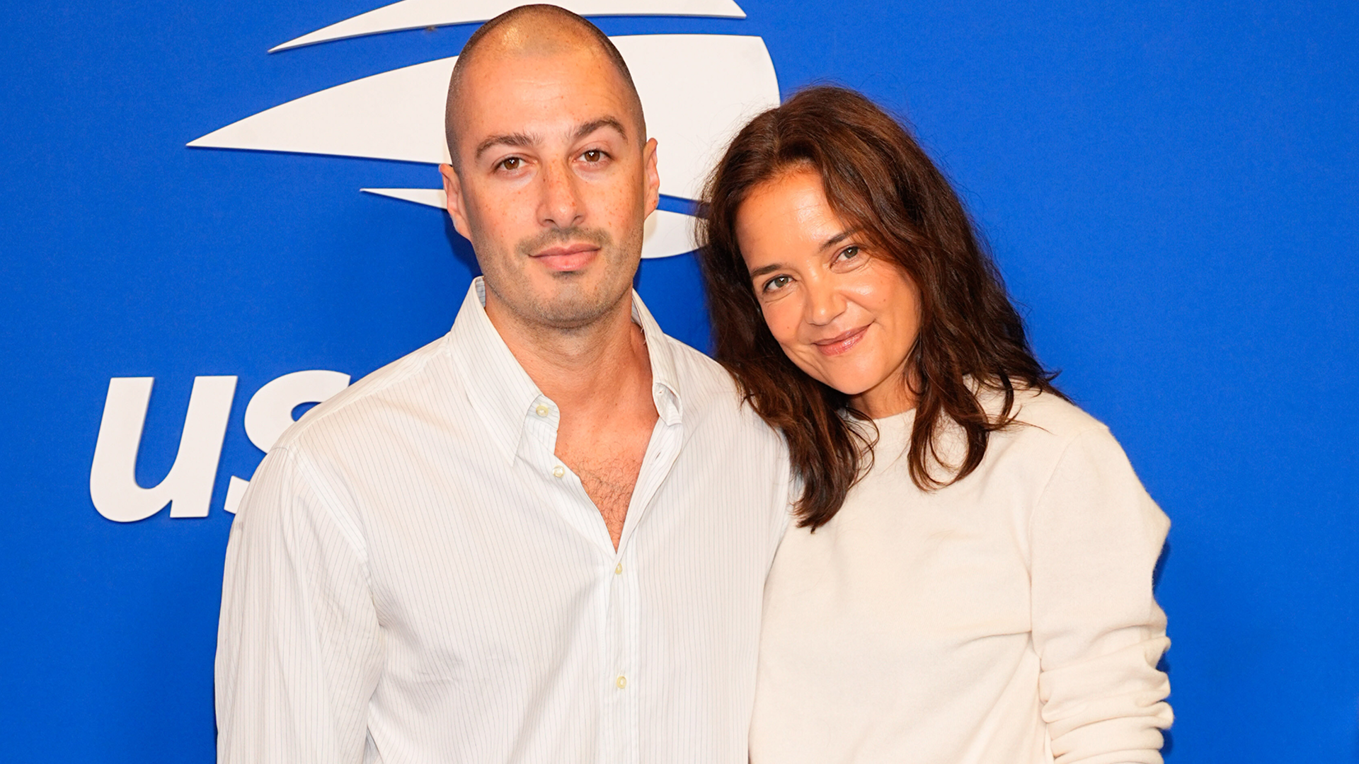 Katie Holmes wore a white crewneck sweater, black trousers, and leather loafers at the 2026 US Open