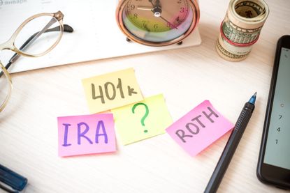 Sticky notes with 401k, IRA and Roth