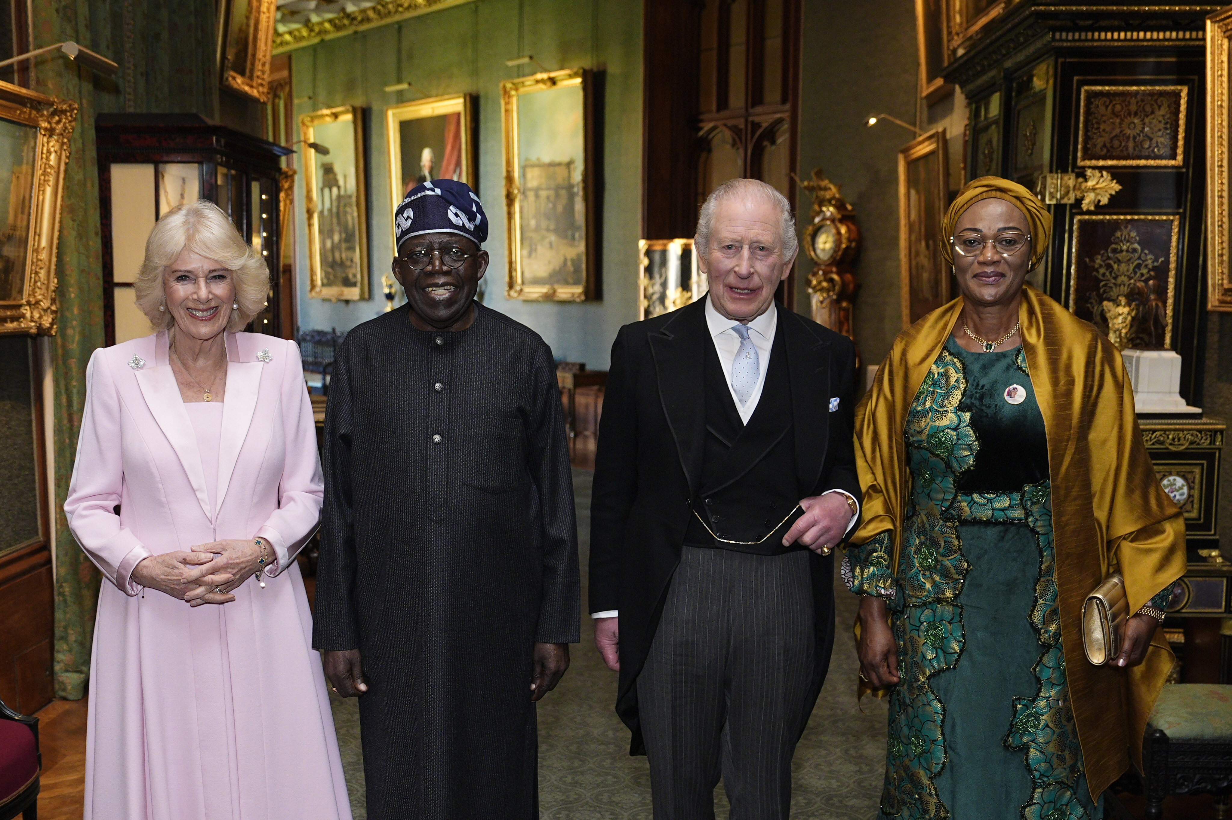 WINDSOR, ENGLAND - MARCH 18: (left to right) Queen Camilla, President of Nigeria Bola Ahmed Tinubu, King Charles III and First Lady Oluremi Tinubu during an audience in the Grand Corridor at Windsor Castle on the first day of State Visit by The President of the Federal Republic of Nigeria on March 18, 2026 in Windsor, England. President Bola Tinubu and First Lady Oluremi Tinubu are conducting a historic State Visit to the United Kingdom, marking the first state visit by a Nigerian leader in 37 years and the first to be hosted at Windsor Castle. (Photo by Aaron Chown - Pool/Getty Images)
