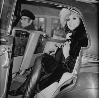 English model and restaurant hostess April Ashley sitting in the back of a car leaving court, UK, 5th February 1970.