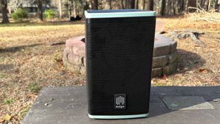 Lodge Solar Powered Speaker 4 outside on a picnic table