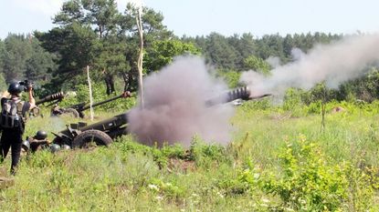 Ukrainian troops fire a howitzer during artillery drills in 2021.