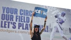 LOS ANGELES, CALIFORNIA - JUNE 21: A protester demonstrates near Dodger Stadium during a protest against the Los Angeles Dodgers organization and ICE immigration raids on June 21, 2025 in Los Angeles, California. Protesters are calling for the Dodgers organization, which has a significant Latino fan base, to do more to support immigrant communities. A series of federal immigration raids have sparked widespread protests and compelled the Trump administration to activate members of the California National Guard and bring in U.S. Marines against the wishes of Gov. Gavin Newsom and city leaders.