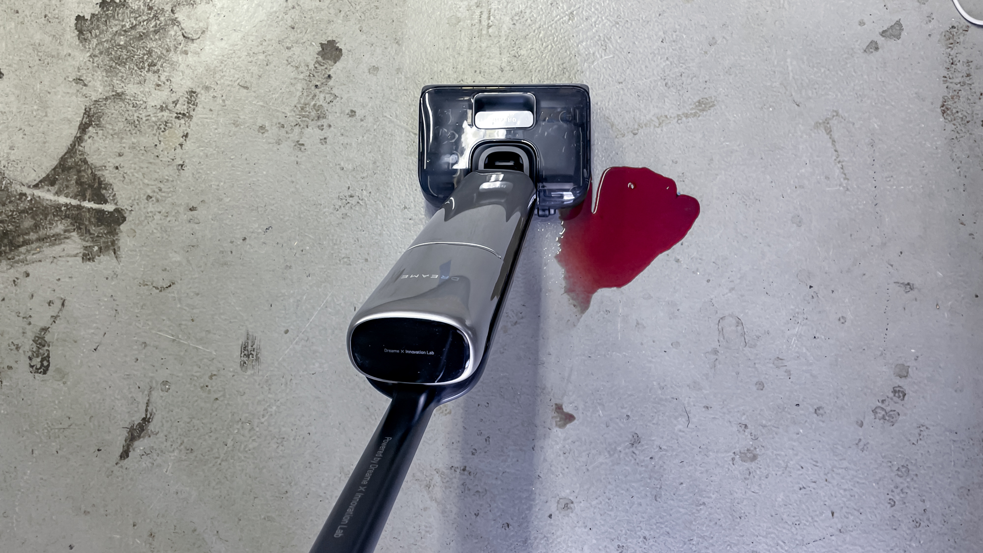 Dreame Aero Pro Wet Dry Vacuum mopping up wine on a concrete floor