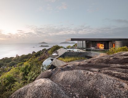 Futuristic residences in the idyllic landscapes of The Seychelles with views of rocks and the ocean