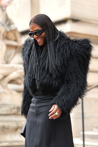 Law Roach in black dress and fur coat