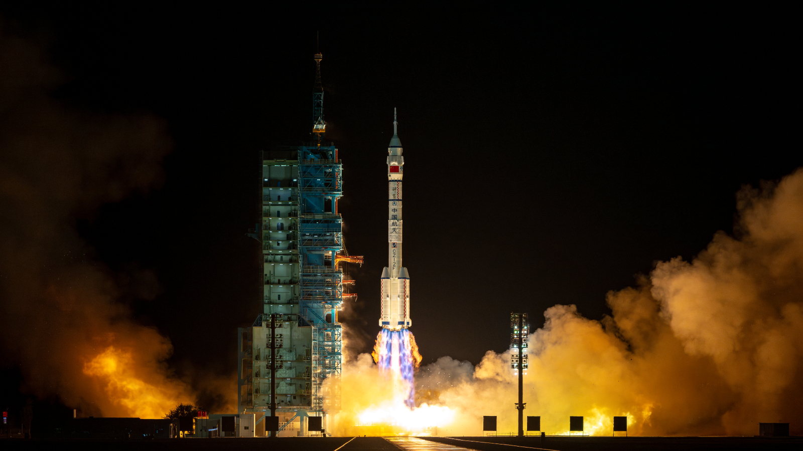 A photo of a Chinese rocket lifting off from a launch pad at night