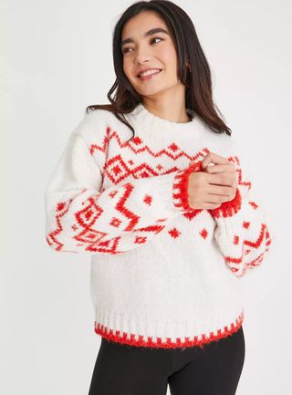 A woman wearing a cream Fair Isle knitted jumper