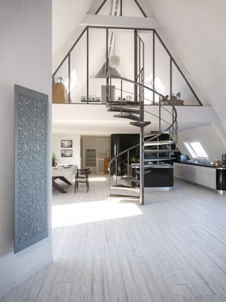 spiral staircase linking to mezzanine floor, pale grey floor, grey radiator, black kitchen