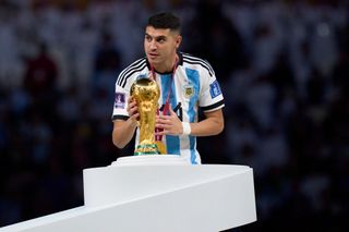 Liverpool target Exequiel Palacios of Argentina, touches the FIFA World Cup Qatar 2022 Winner's Trophy during the awards ceremony after the FIFA World Cup Qatar 2022 Final match between Argentina and France at Lusail Stadium on December 18, 2022 in Lusail City, Qatar. (Photo by Juan Luis Diaz/Quality Sport Images/Getty Images)