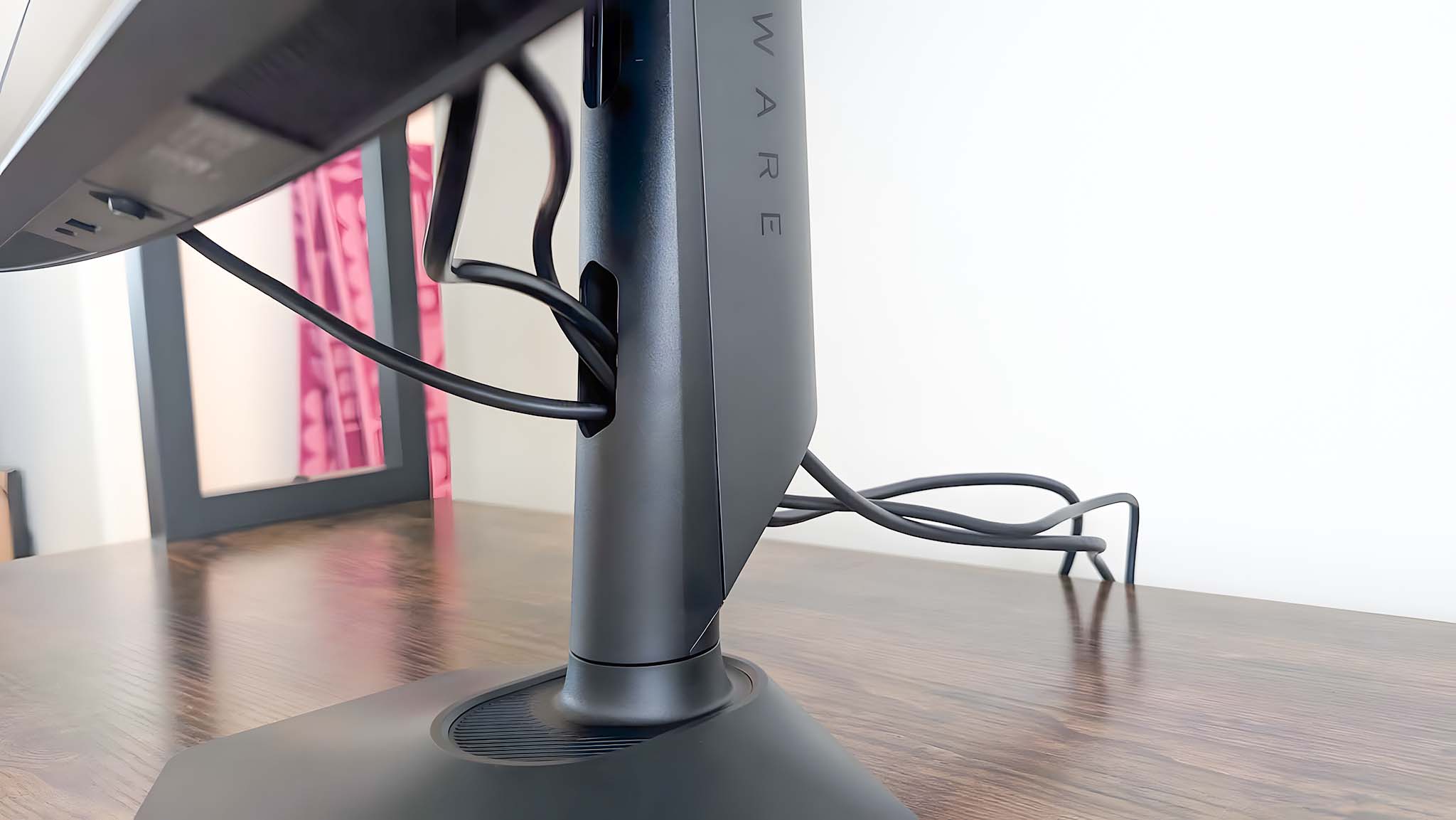 Image showing cables going through the Alienware AW2725QF Gaming Monitor's cable tidy hole.