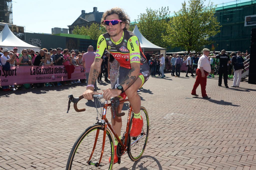 Filippo Pozzato on an old steel Wilier bike rides to sign on