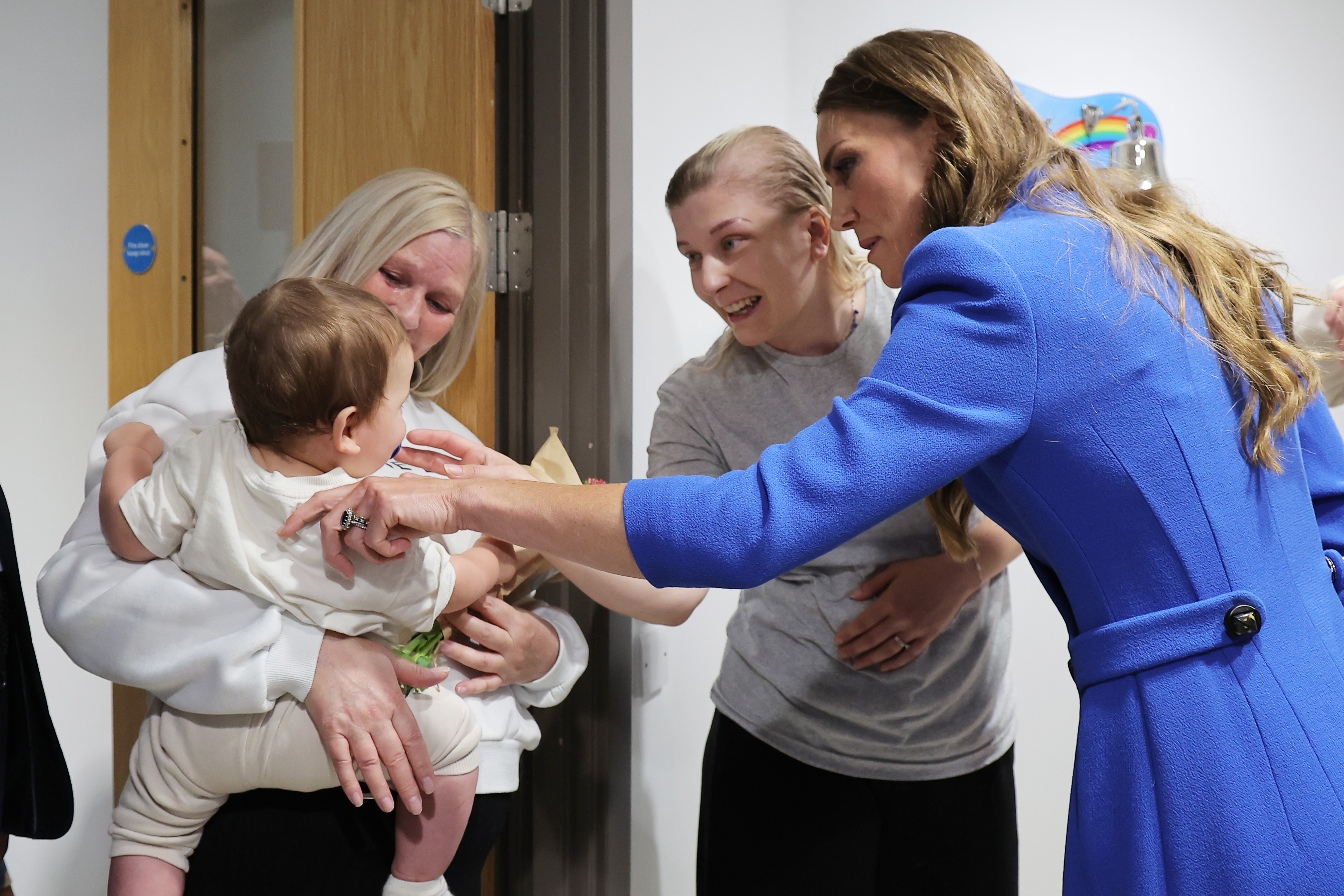 Princess Kate meeting a baby at a cancer hospital