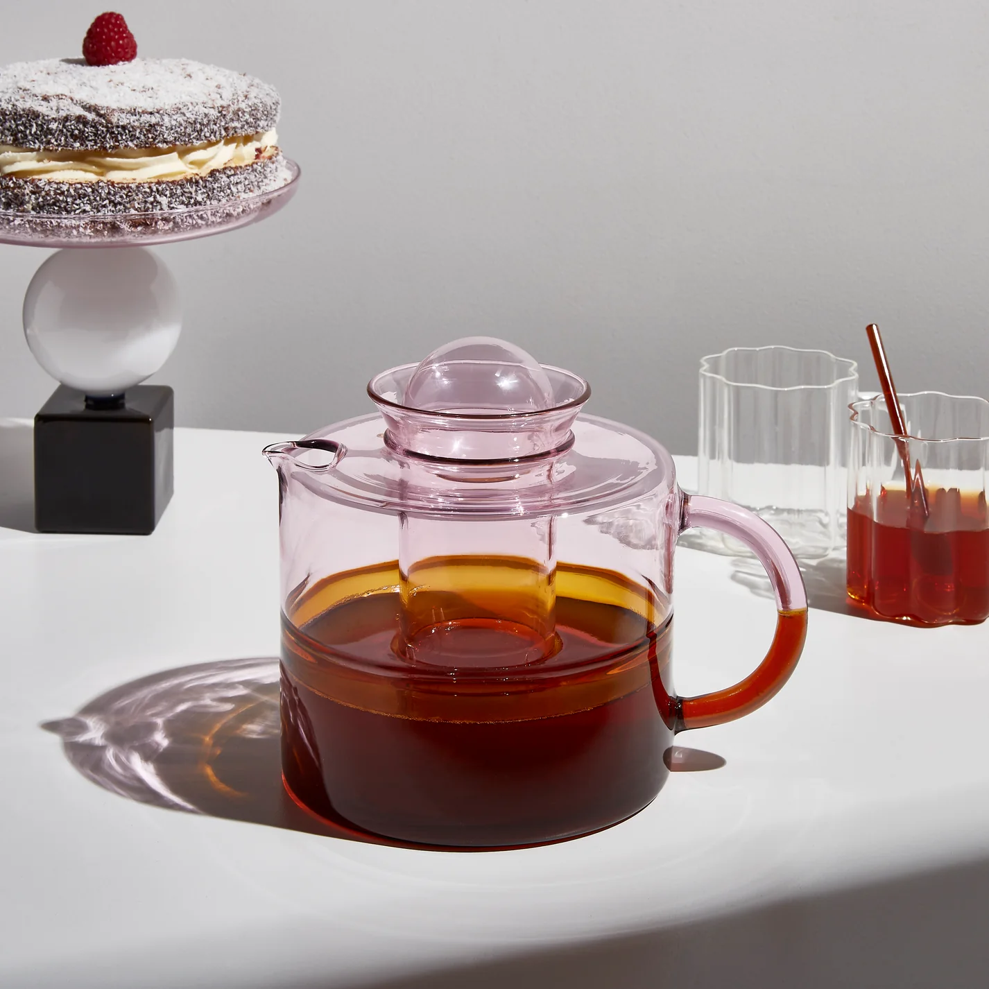 Pink FAZEEK teapot alongside coordinating serveware