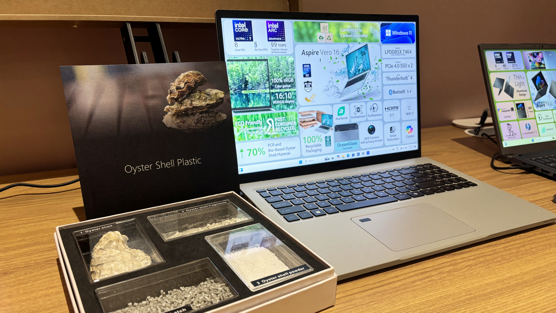 Acer Aspire Vero 16 laptop on a table at CES next to its Oyster Shell Plastic demonstration box