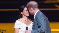 Prince Harry, Duke of Sussex and Meghan, Duchess of Sussex kiss during the Invictus Games 2020 Opening Ceremony at Zuiderpark on April 16, 2022 in The Hague, Netherlands. 