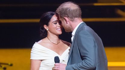 Prince Harry, Duke of Sussex and Meghan, Duchess of Sussex kiss during the Invictus Games 2020 Opening Ceremony at Zuiderpark on April 16, 2022 in The Hague, Netherlands. 