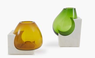 Hand-blown, biomorphic glass forms are fused seamlessly into marble bases
