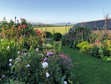 Cottage-garden planting and endless views at Jasper Conran’s garden at Bettiscombe Manor in Dorset, on G&T Garden Tours.