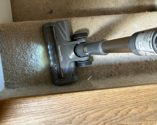Kenmore Elite cordless vacuum being used on carpeted stairs
