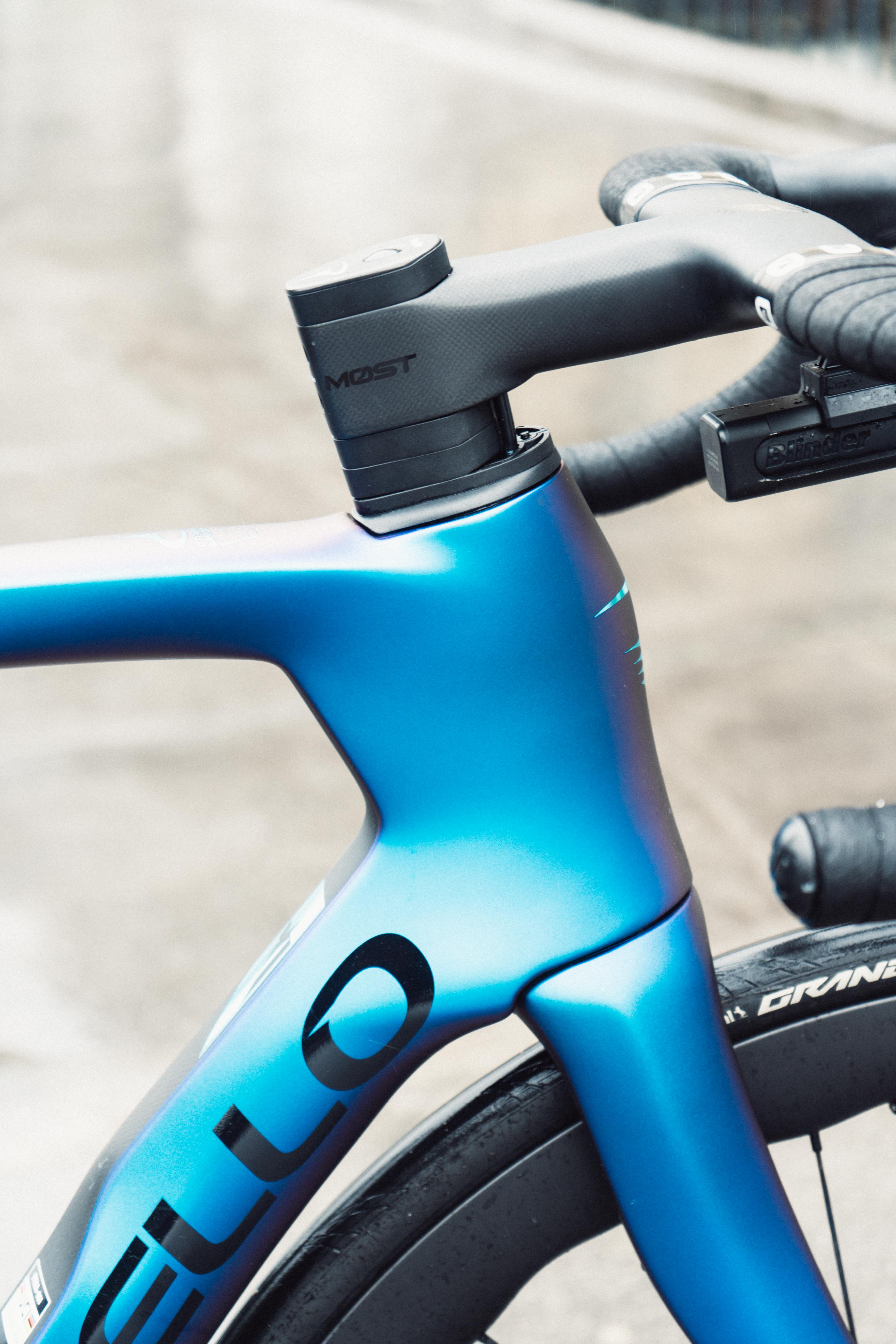 A close up of the head tube of a blue bike