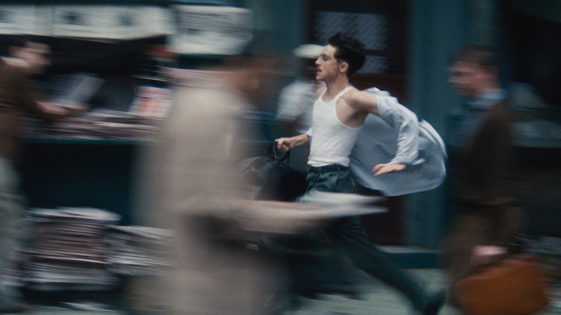 Still from Marty Supreme film, man running in street