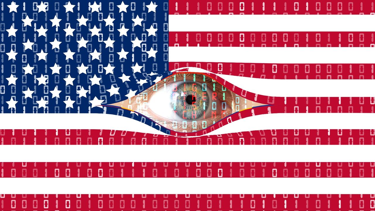 A surveillance &quot;Big Brother&quot; eye is watching from behind the digital curtain of the American flag