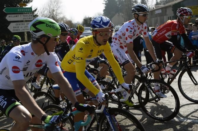 Netherlands' Moreno Hofland (L) wearing the best young's white jersey, France's Nacer Bouhanni (C) wearing the overall leader's yellow jersey, and France's Christophe Laborie (2ndR) wearing the best climber's polka dot jersey