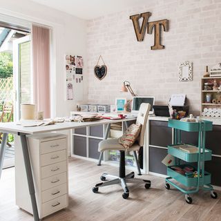 work space with white brick wall white desk with chair and wooden floor