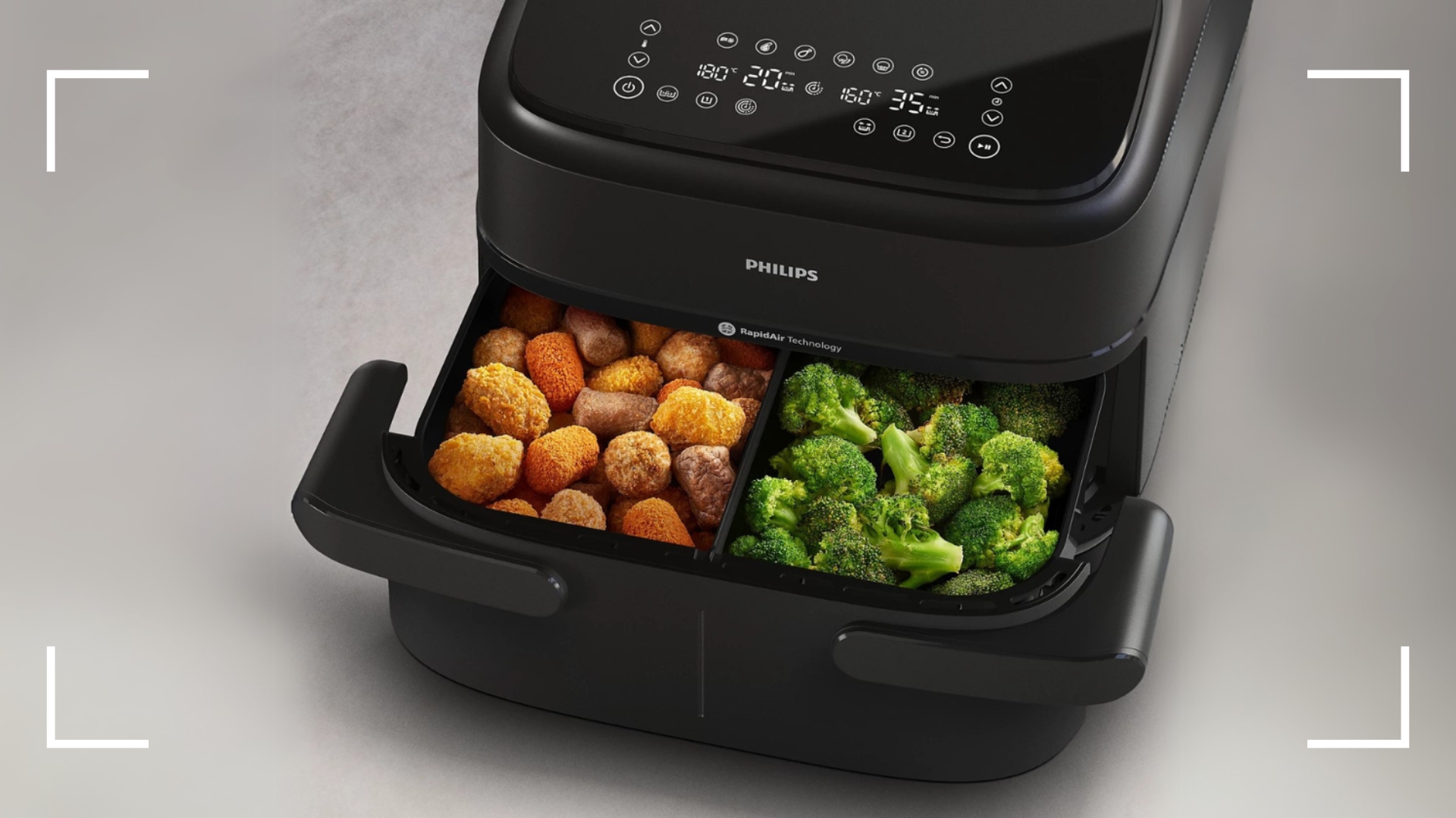 The Philips Series 100 Flexible Air Fryer cooking two types of vegetables in its drawer with the divider in place