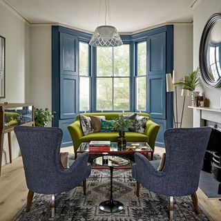 sitting room with green sofa cushion and grey chair