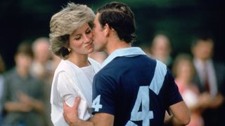 Prince Charles kissing a young Princess Diana at a polo match, he's in his polo kit and she in a sailors blouse,