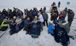 From left to right: European Space Agency astronaut Alex Gerst, Russian cosmonaut Sergey Prokopyev and NASA astronaut Serena Auñón-Chancellor get checked out by medics after their Soyuz MS-09 spacecraft landed on Dec. 20, 2018.