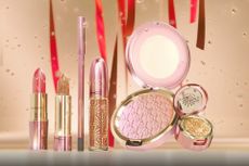 A range of MAC cosmetics including a lipstick, gloss and powder