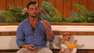 Davide with the baby and crisps on Love Island UK