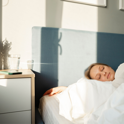 A woman sleeping while using one of the best sleep tracking apps