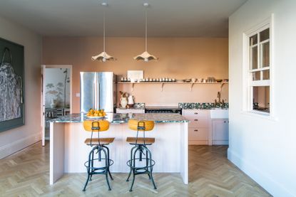Pink kitchen with marble island