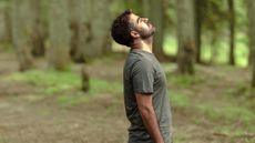 Man breathing outside in a forest