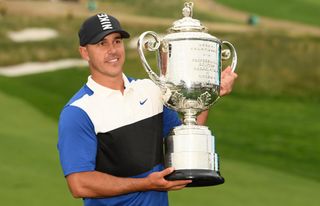 Brooks Koepka holds the PGA Championship trophy in 2019