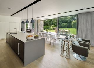 grey modern kitchen with wooden flooring and large sliding doors