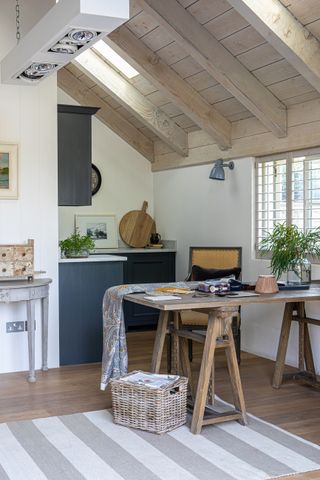 Office in rustic shed with workshop desk and natural light