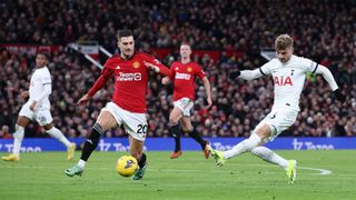 Tottenham&#039;s Timo Werner shoots as Man Utd&#039;s Diogo Dalot tries to incercept during the sides&#039; January 2024 Premier League encounter.