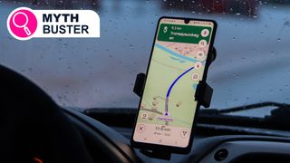 A phone showing Google Maps mounted to a car dashboard
