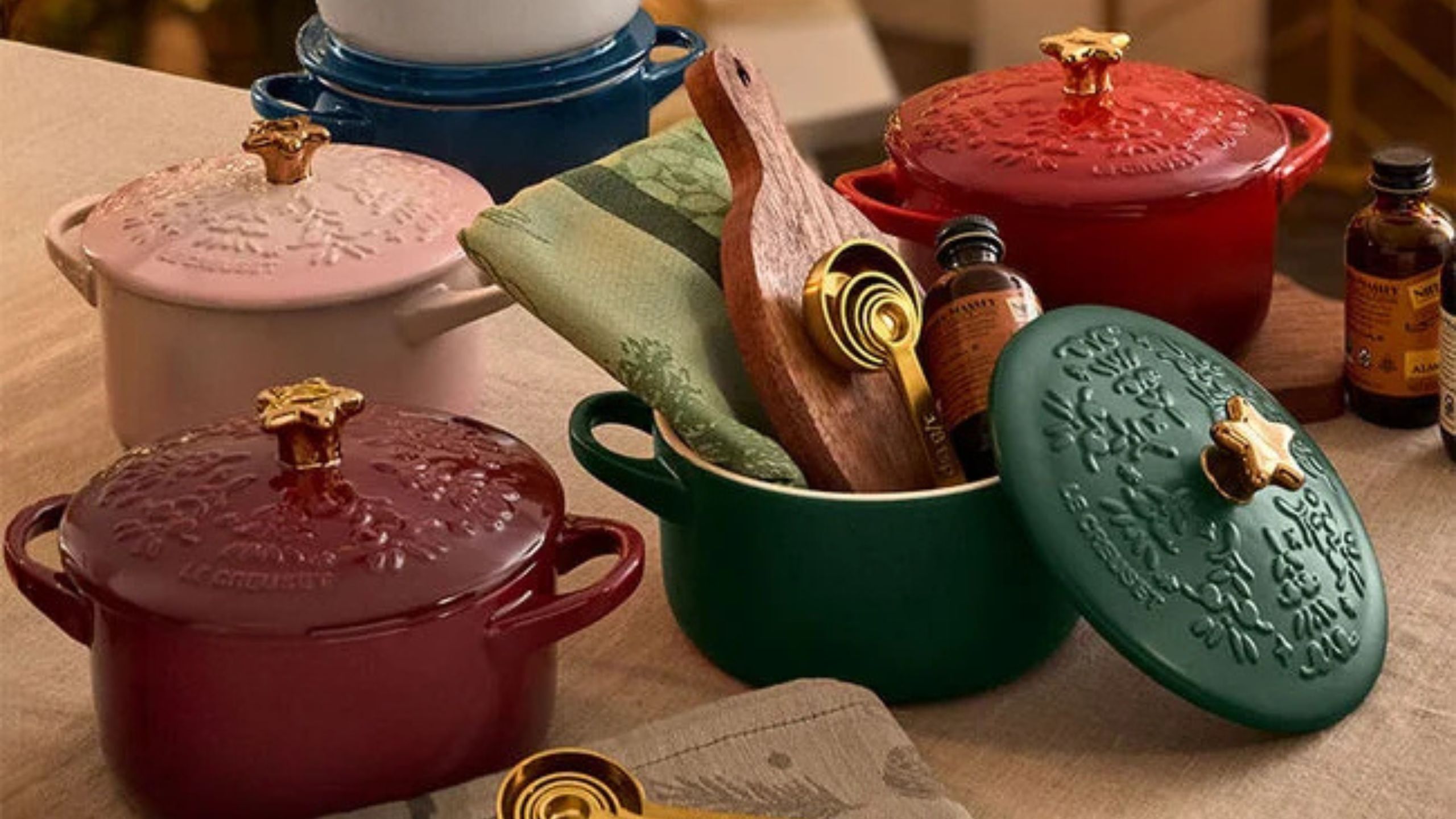 A collection of small cocottes in festive colors, with small star shaped lid knobes. 