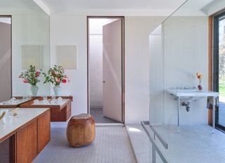 Bright bathroom in the Luss House with tiled floor and wooden furniture