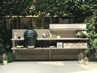an outdoor kitchen set up with a green egg cooker