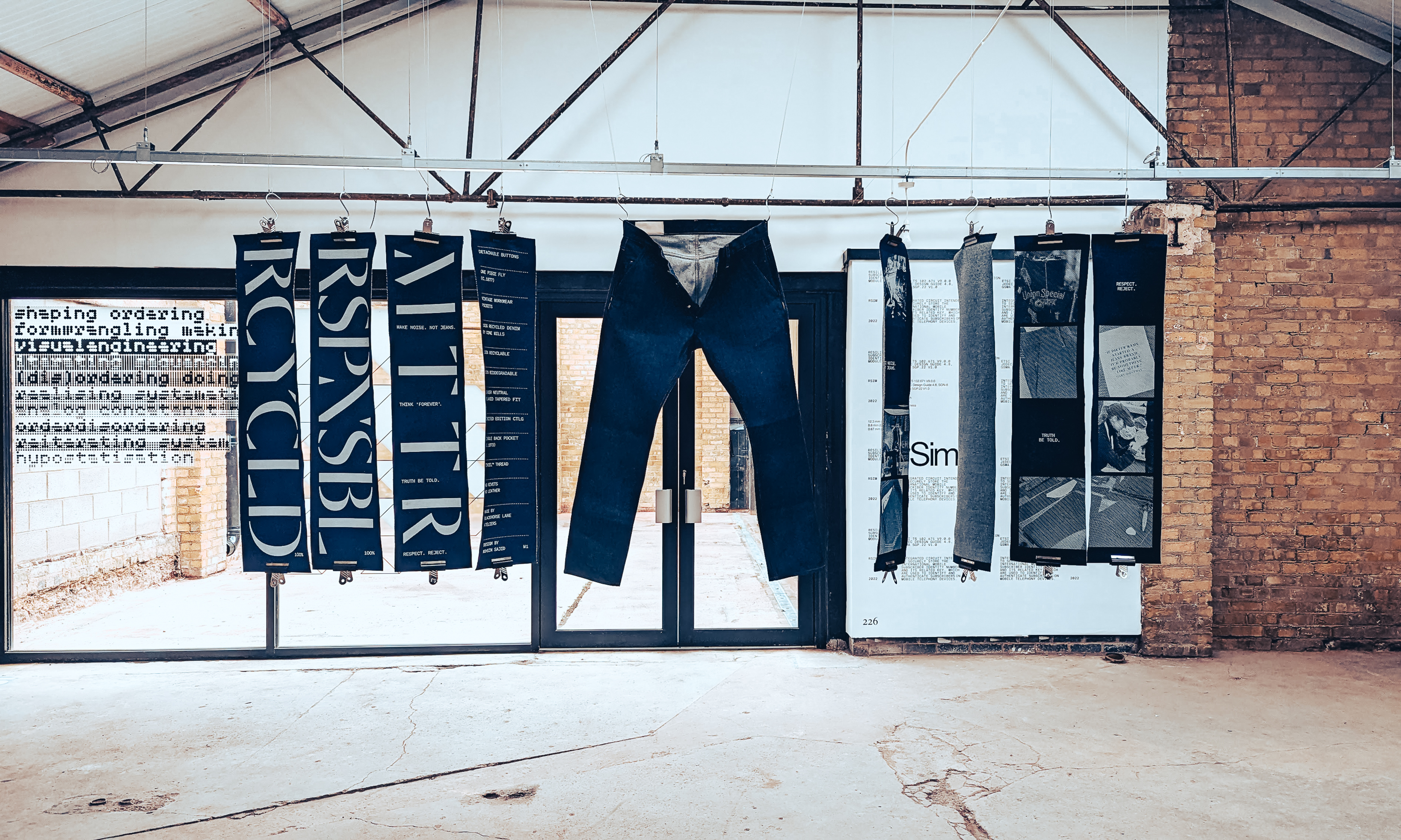 MTTR jeans hanging on a line with publishing material