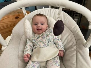 Our tester's baby, Freddie, pictured sitting in the Apollo baby bouncer from Mamas and Papas and smiling broadly